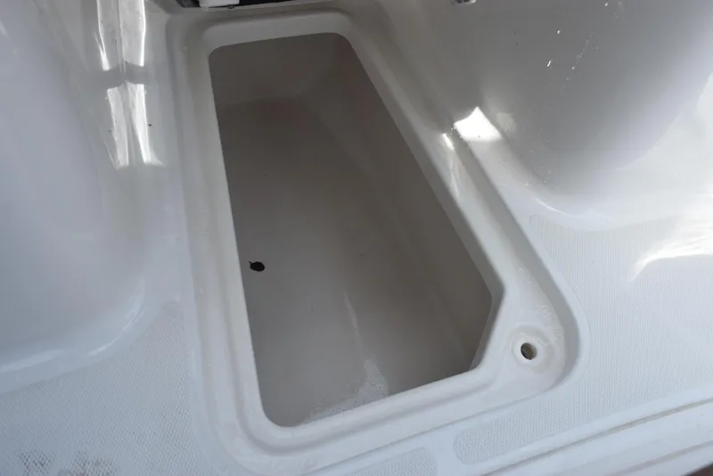 Slide: The Image of Storage compartment on 2021 Sea Hunt Ultra 255 SE boat, white interior. - 19