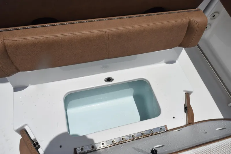 Slide: The Image of 2021 Sea Hunt Ultra 255 SE boat seat with storage compartment open. - 21