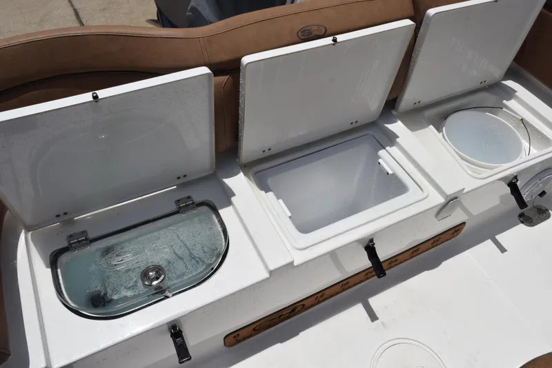 Slide: The Image of Open storage compartments on a 2021 Sea Hunt Ultra 255 SE boat. - 23