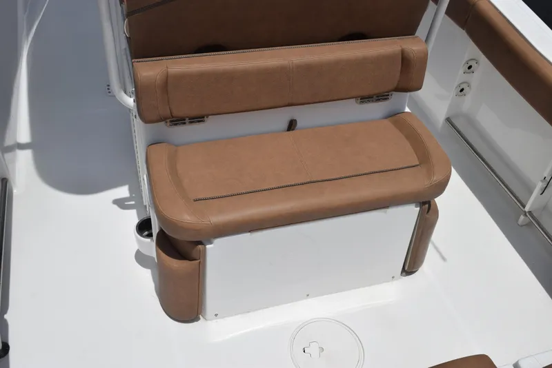 Slide: The Image of Brown cushioned seating on 2021 Sea Hunt Ultra 255 SE boat interior. - 8