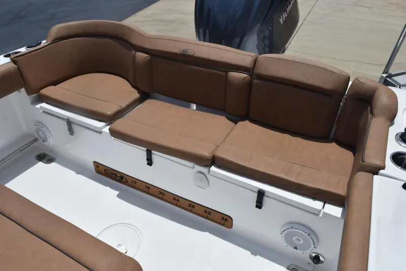 Slide: The Image of Luxurious brown seating on 2021 Sea Hunt Ultra 255 SE boat, featuring spacious and comfortable design. - 9