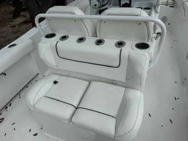 Slide: The Image of 2016 Sea Hunt Gamefish 27 boat interior with white seating and cup holders. - 11