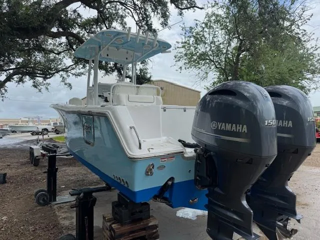 Slide: The Image of 2016 Sea Hunt Gamefish 27 boat with dual Yamaha 150 engines, parked outdoors. - 5