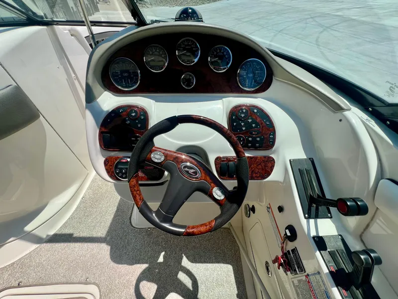 Slide: The Image of 2007 Sea Ray 290 SLX boat dashboard with steering wheel and control panel. - 10