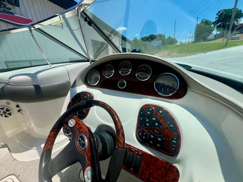 Slide: The Image of 2007 Sea Ray 290 SLX dashboard with wood accents and steering wheel. - 12