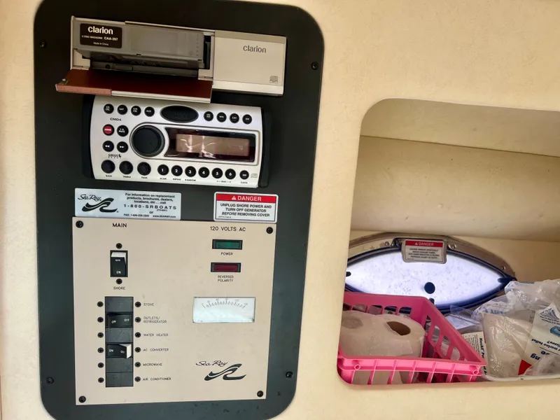 Slide: The Image of 2007 Sea Ray 290 SLX control panel with Clarion audio system and storage compartment. - 13