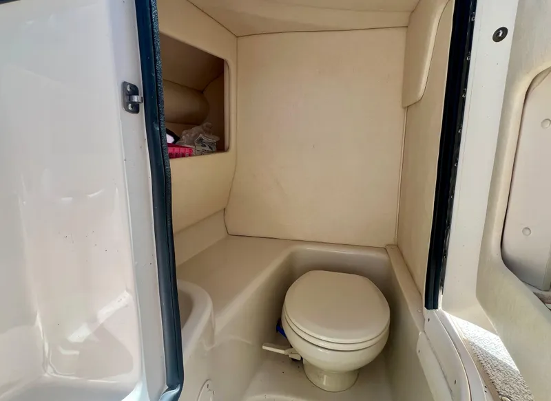 Slide: The Image of 2007 Sea Ray 290 SLX boat interior with compact marine toilet. - 14