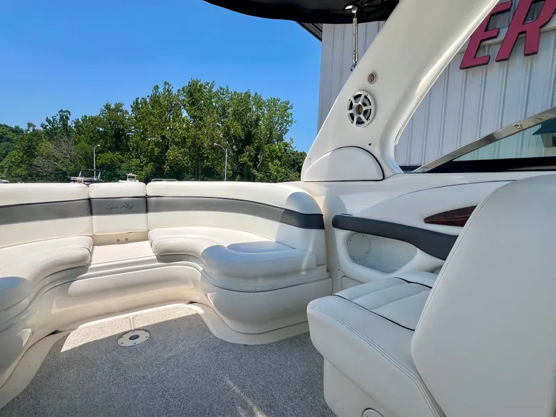 Slide: The Image of Interior of a 2007 Sea Ray 290 SLX boat with white seating and speaker. - 7