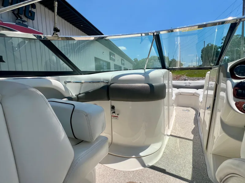 Slide: The Image of Interior view of 2007 Sea Ray 290 SLX boat with white seating and clear windshield. - 9