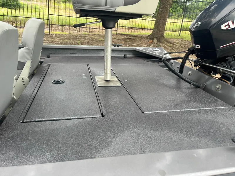 Slide: The Image of 2012 Alumacraft Pro 165 boat interior with seating and motor, outdoors. - 11