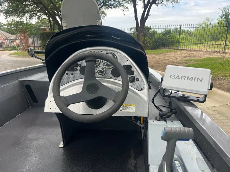 Slide: The Image of 2012 Alumacraft Pro 165 boat dashboard with steering wheel and Garmin GPS system. - 14