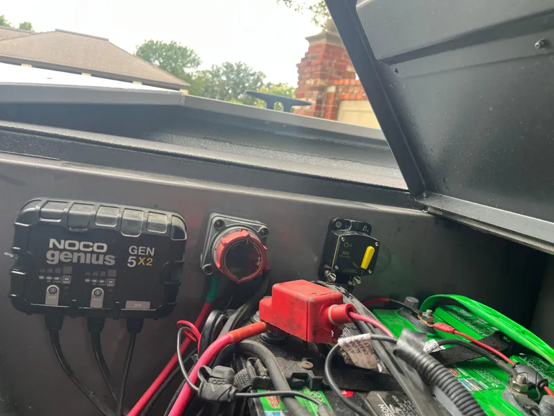 Slide: The Image of 2012 Alumacraft Pro 165 boat battery compartment with NOCO Genius charger and wiring. - 16