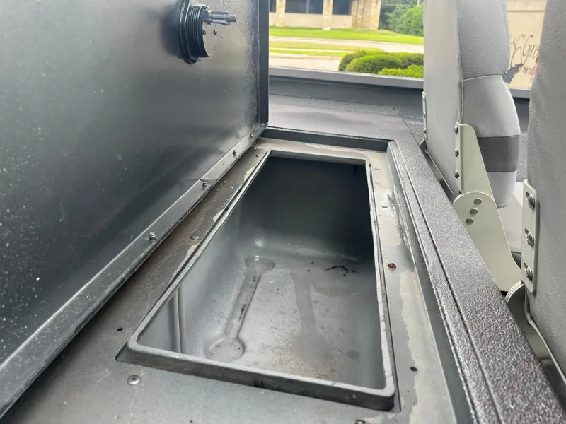 Slide: The Image of Open storage compartment in a 2012 Alumacraft Pro 165 boat interior. - 17