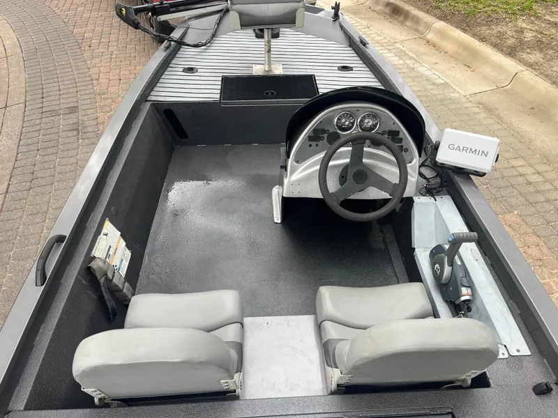 Slide: The Image of 2012 Alumacraft Pro 165 boat interior with steering wheel and Garmin device. - 20