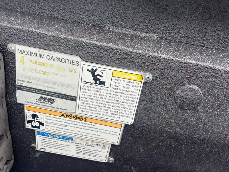 Slide: The Image of Warning labels on 2012 Alumacraft Pro 165 boat, indicating maximum capacity and safety instructions. - 23