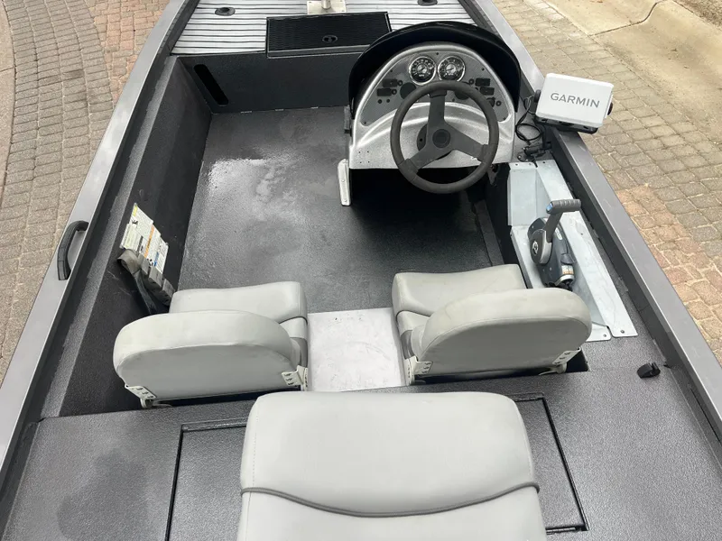 Slide: The Image of 2012 Alumacraft Pro 165 boat interior with steering wheel and Garmin device. - 24