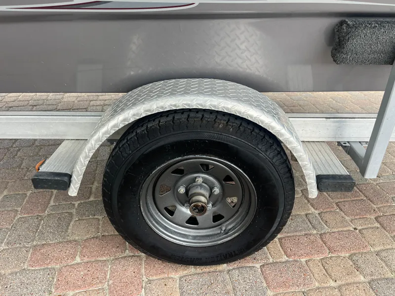 Slide: The Image of Trailer wheel of 2012 Alumacraft Pro 165 boat on brick pavement. - 25