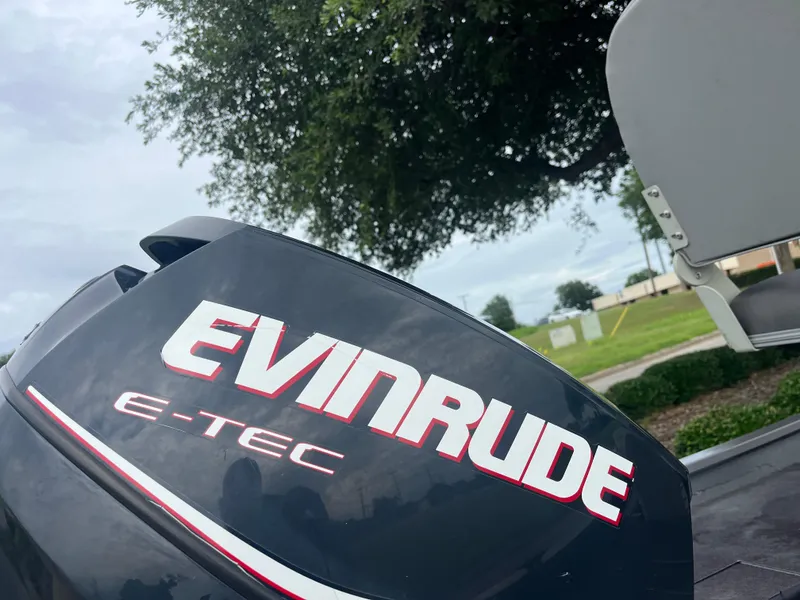 Slide: The Image of Evinrude E-TEC outboard motor on 2012 Alumacraft Pro 165 boat, outdoor setting. - 30