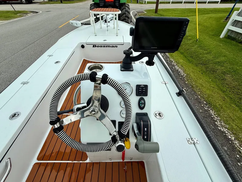 Slide: The Image of Steering console of a 2014 Bossman TailSpotter boat with navigation equipment. - 10