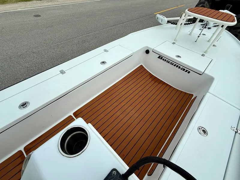 Slide: The Image of 2014 Bossman TailSpotter boat interior with teak flooring and storage compartments. - 12
