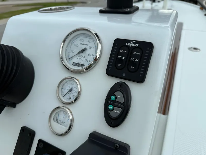 Slide: The Image of Control panel of a 2014 Bossman TailSpotter boat with gauges and switches. - 18