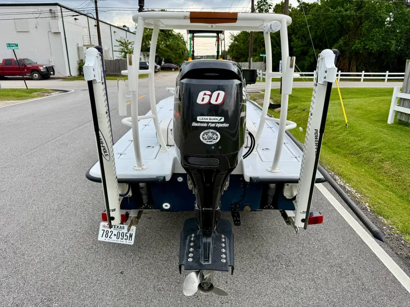 Slide: The Image of Rear view of a 2014 Bossman TailSpotter boat with a 60 HP outboard motor. - 3