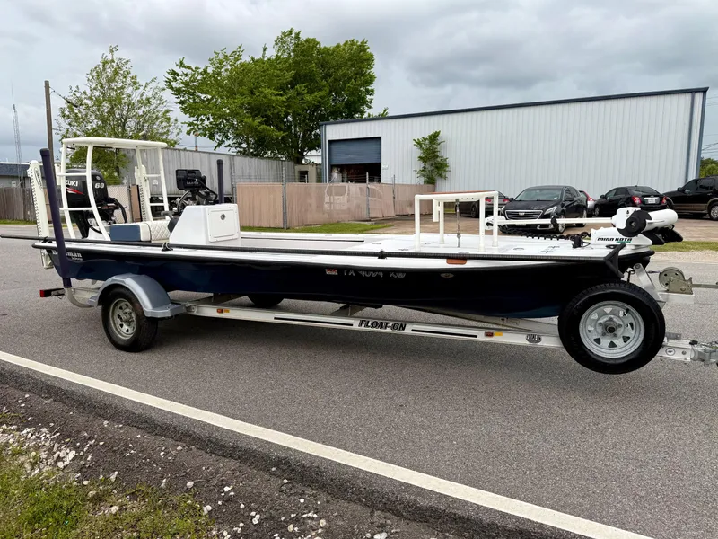 Slide: The Image of 2014 Bossman TailSpotter boat on trailer, parked on roadside near industrial building. - 5