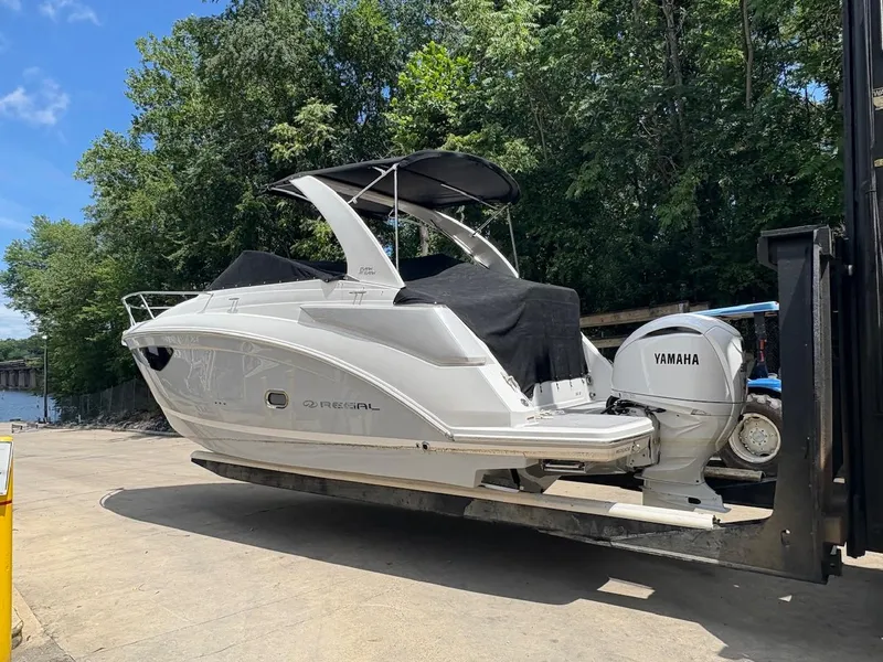 Slide: The Image of 2022 Regal 26 XO boat dashboard with steering wheel and control panel. - 12