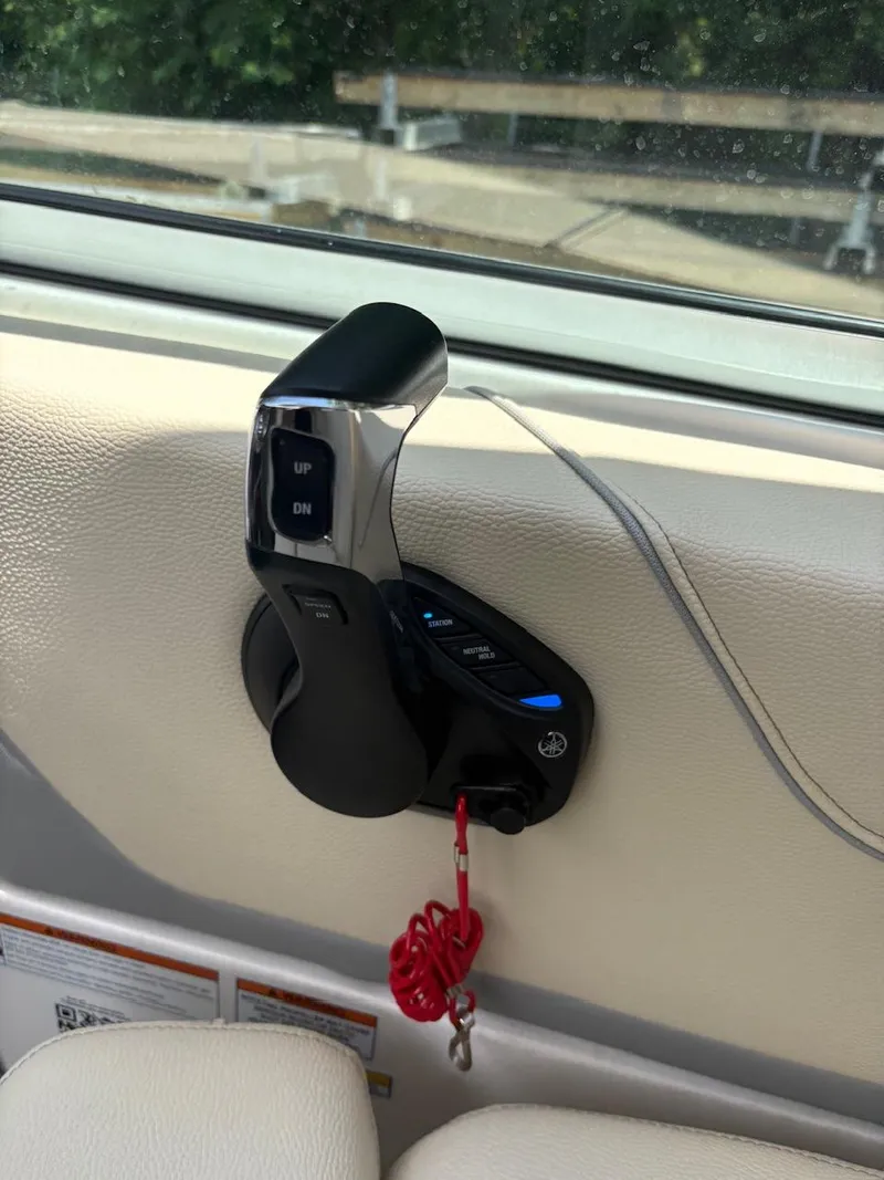 Slide: The Image of Throttle control lever on a 2022 Regal 26 XO boat interior. - 14