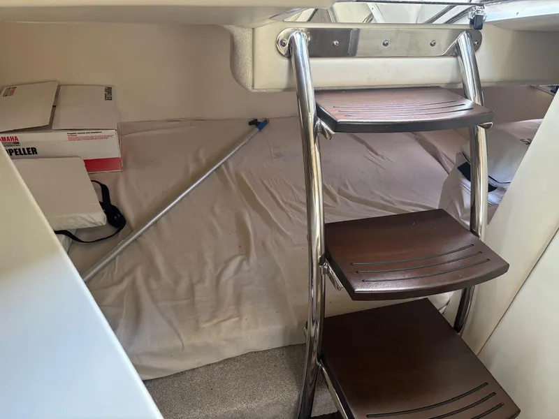 Slide: The Image of Interior of 2022 Regal 26 XO boat with wooden steps and storage area. - 15