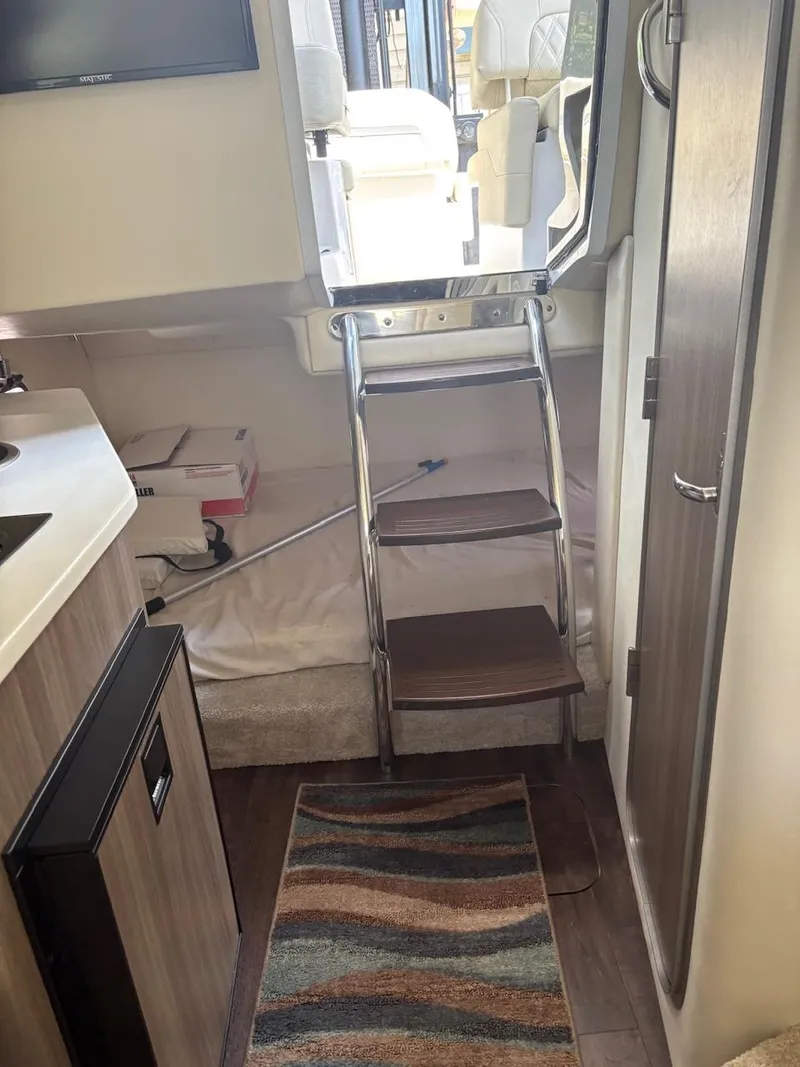 Slide: The Image of Interior of a 2022 Regal 26 XO boat with ladder and cozy cabin space. - 17