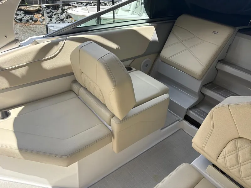 Slide: The Image of 2022 Regal 26 XO boat interior with beige seating and cup holder. - 22