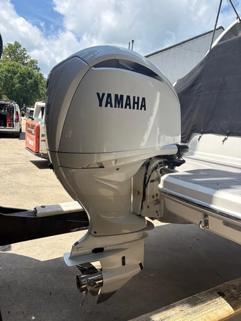 Slide: The Image of Yamaha outboard motor on 2022 Regal 26 XO boat, parked outdoors. - 25