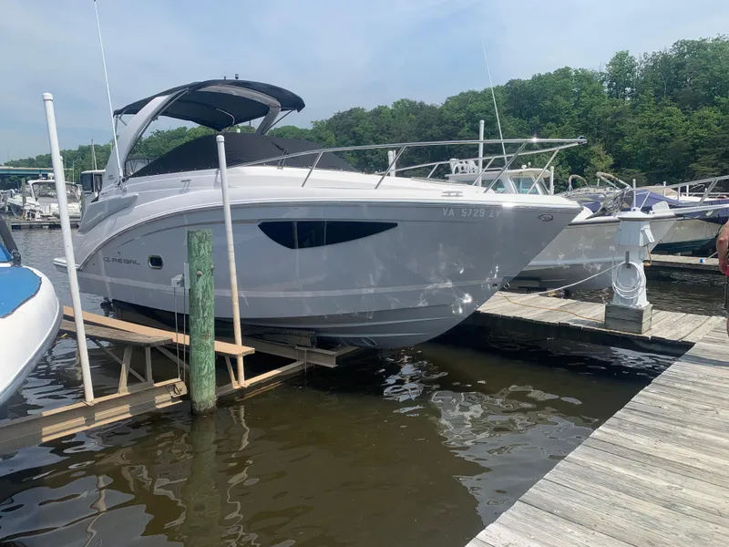 Slide: The Image of 2022 Regal 26 XO boat on calm water under clear blue sky. - 3