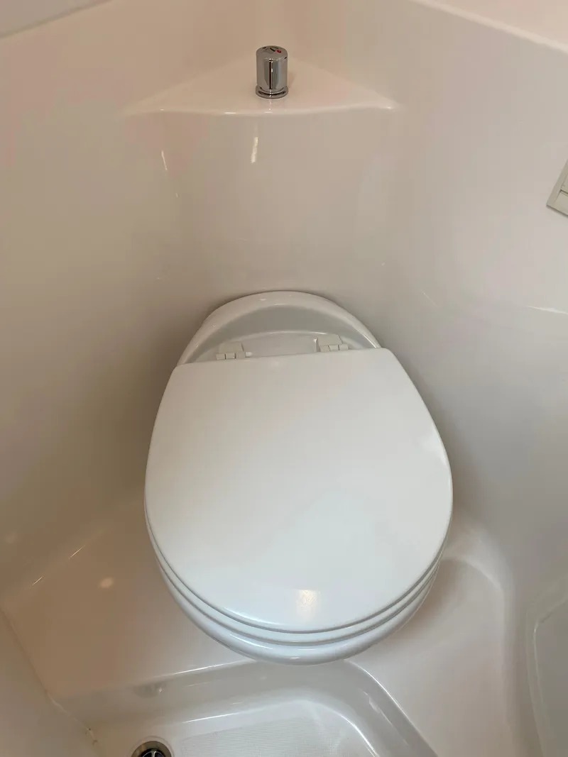 Slide: The Image of Compact bathroom in 2022 Regal 26 XO boat with toilet and sink. - 5