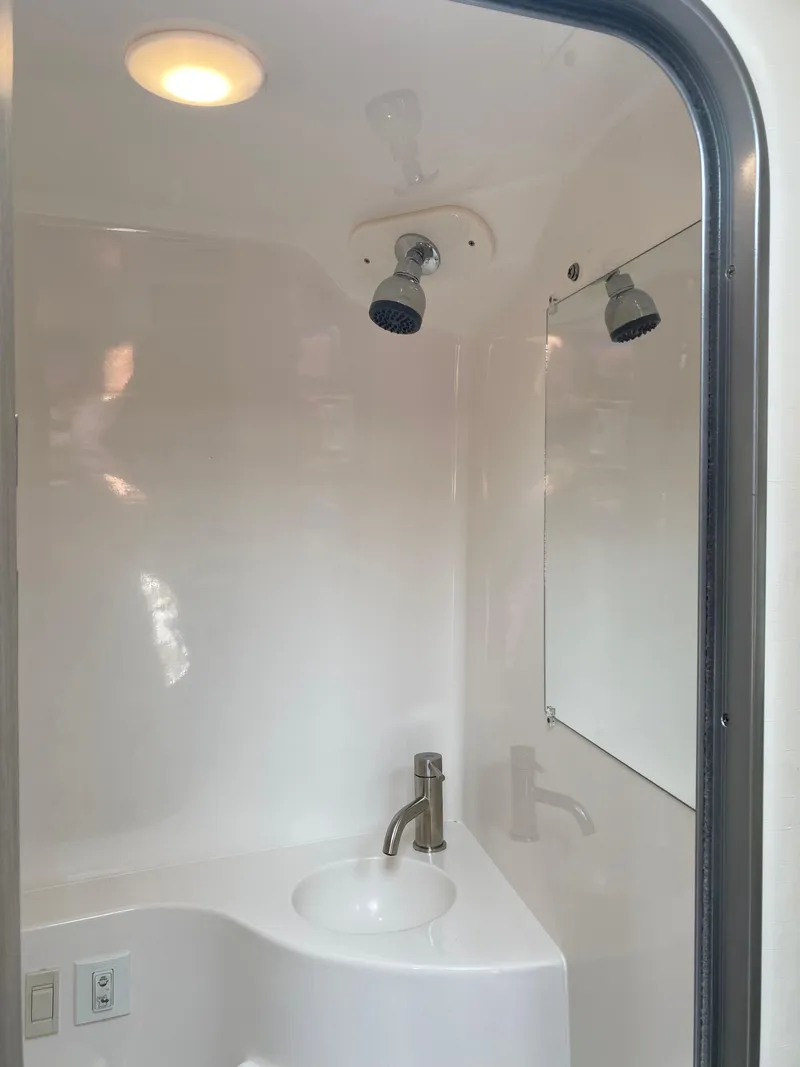 Slide: The Image of White toilet in a 2022 Regal 26 XO boat bathroom. - 6