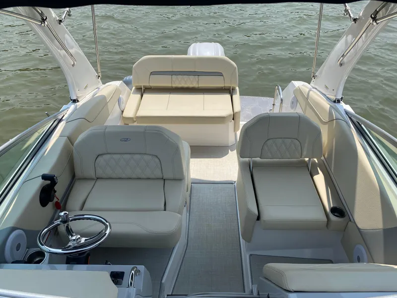 Slide: The Image of Luxurious interior of 2022 Regal 26 XO boat with beige seating and cup holders. - 9