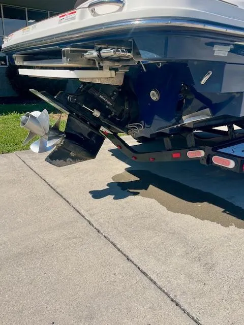 Slide: The Image of 2020 Sea Ray SLX 250 boat on trailer, showing propeller and stern drive. - 14