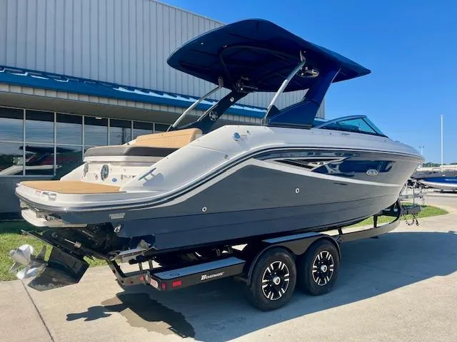 Slide: The Image of 2020 Sea Ray SLX 250 boat on trailer, sleek design, blue and white exterior. - 2
