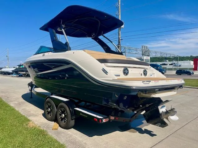 Slide: The Image of 2020 Sea Ray SLX 250 boat on trailer, parked outdoors under clear blue sky. - 3