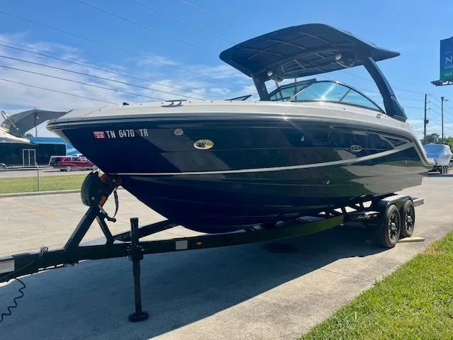 Slide: The Image of 2020 Sea Ray SLX 250 boat on trailer, parked outdoors under clear blue sky. - 4