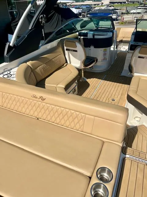 Slide: The Image of 2020 Sea Ray SLX 250 boat interior with tan leather seating and wood flooring. - 6