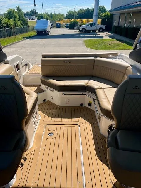 Slide: The Image of 2020 Sea Ray SLX 250 boat interior with tan leather seating and teak flooring. - 9