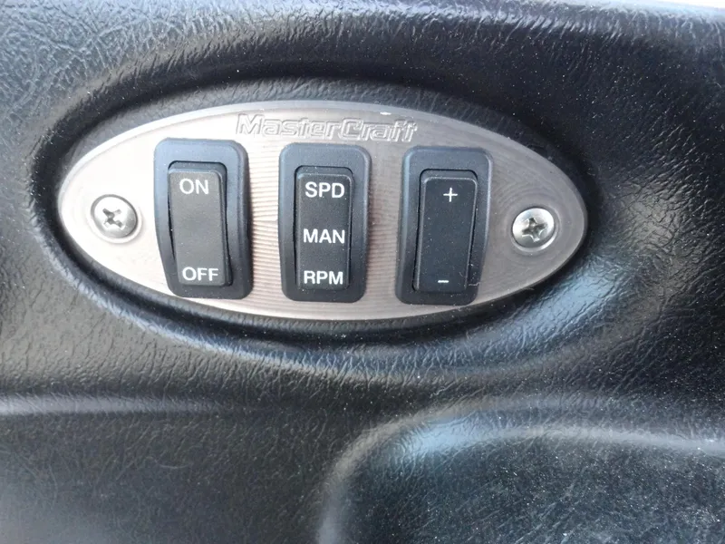 Slide: The Image of Control panel of a 2006 MasterCraft X-45 boat with switches and buttons. - 11