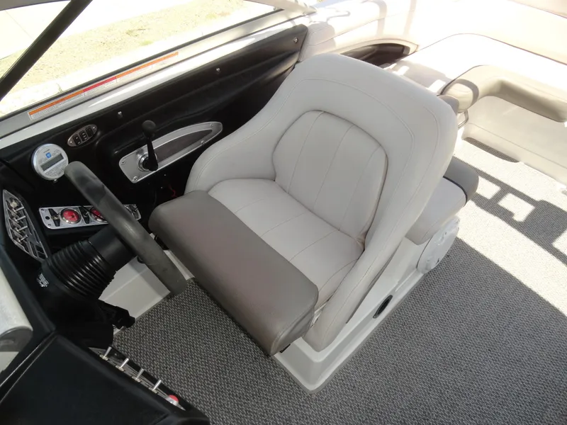 Slide: The Image of Captain's seat in 2006 MasterCraft X-45 boat, featuring a sleek dashboard and controls. - 12