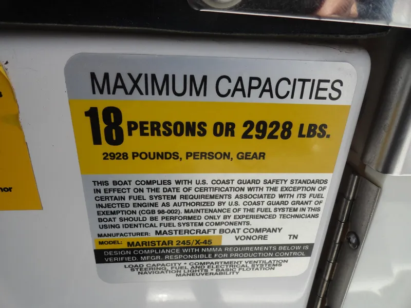 Slide: The Image of 2006 MasterCraft X-45 capacity label: 18 persons or 2928 lbs, compliance details included. - 14