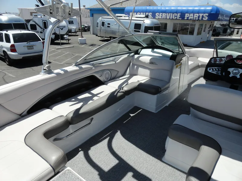 Slide: The Image of 2006 MasterCraft X-45 boat interior with seating and dashboard in a dealership lot. - 15