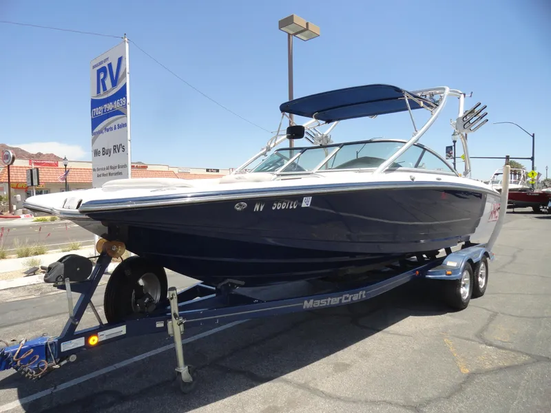 Slide: The Image of 2006 MasterCraft X-45 boat on trailer at RV dealership under clear blue sky. - 2