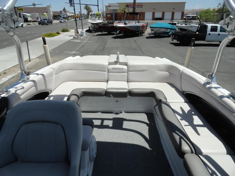 Slide: The Image of 2006 MasterCraft X-45 boat interior with spacious seating, parked in a lot. - 21