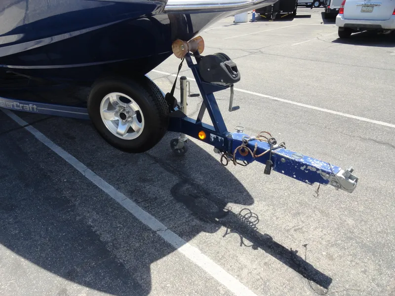 Slide: The Image of Trailer hitch of a 2006 MasterCraft X-45 boat in a parking lot. - 25